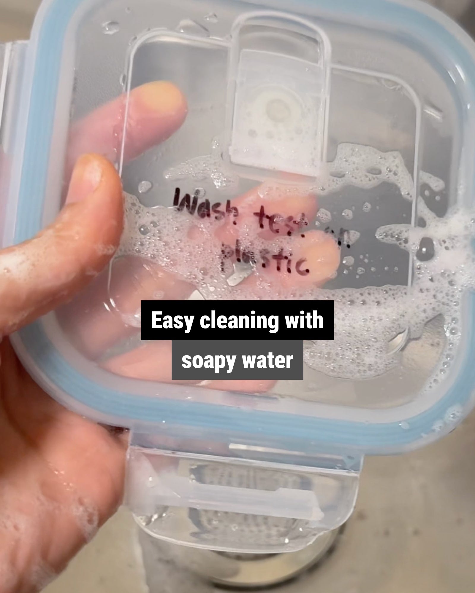 Writing on a food container lid being removed with soapy water